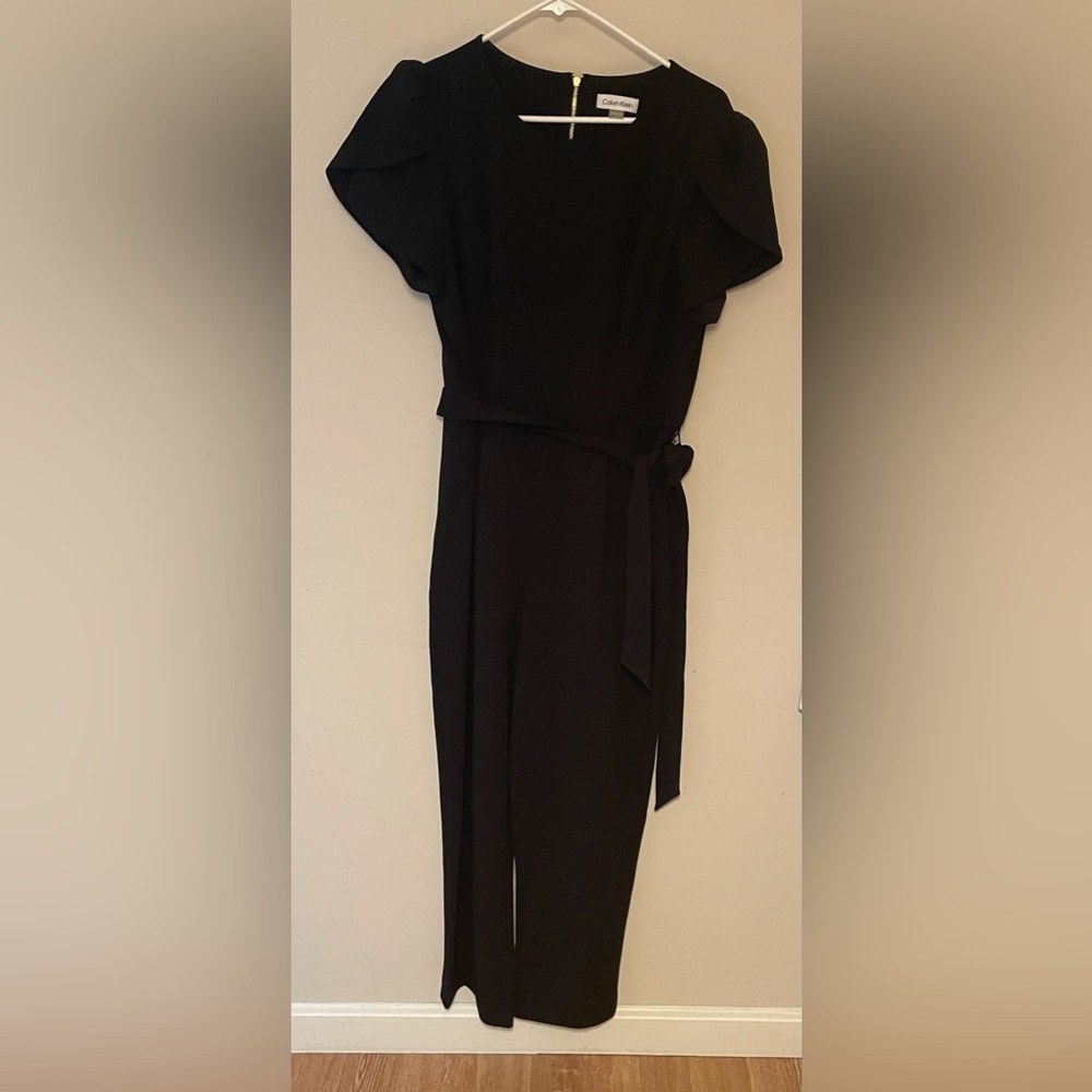 Women’s Calvin Klein black pantsuit, gold zipper size 14.  Excellent condition.